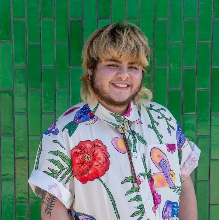 Artist Statement: Sam Sequeira (they/them)
Transitioning is allowing yourself to have a part in your own creation. As a trans ceramicist, I cannot help but notice the parallels of clay to ceramic and my current medical transition. This exploration and display of my identity feels more imperative than ever with the constant attack on trans existence and rights. I often use my work to demand space and force representation as resistance whether in a functional form or figurative vessel. Self-expression and gender identity have always been on a spectrum in my eyes, and the vessels mirror that. My use of mixed media is new to my work, but is an homage to my textile ancestry and love for accessorizing. The choice of materials felt intuitive at first, but now I understand I am using textiles, wire, and ceramic to act as a trinity of my matriarchal lineage of my grandmother, mother, and myself.
Website: https://www.theclaygay.com